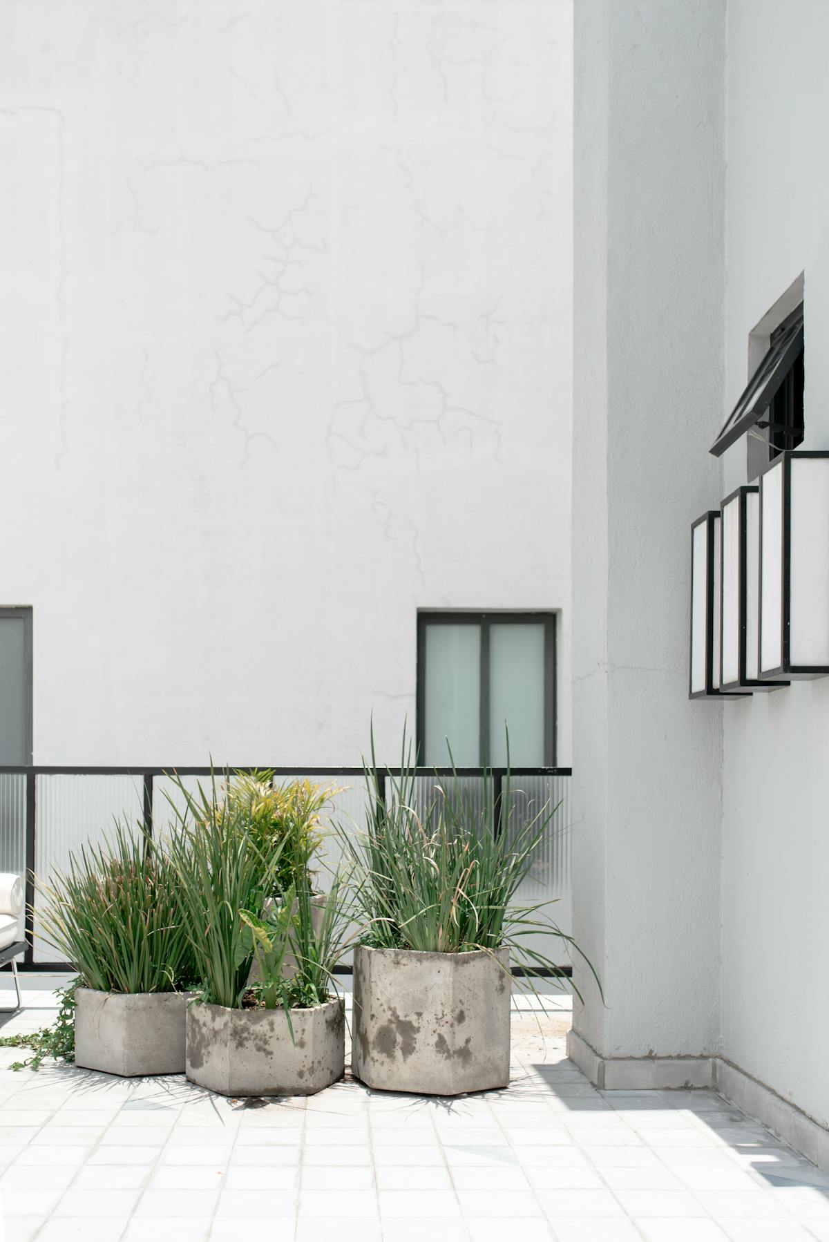 Outdoor Planter Box Singapore: The Complete 2026 Guide for HDB Balconies, Condos and Rooftops 2 Minimalist Singapore condo balcony with potted plants in modern outdoor planter boxes